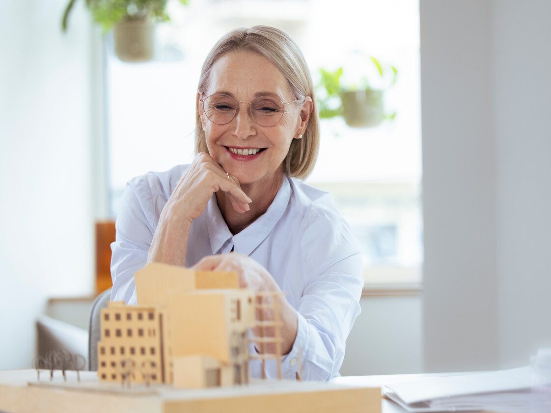 Smiling businesswoman checking model at workplace