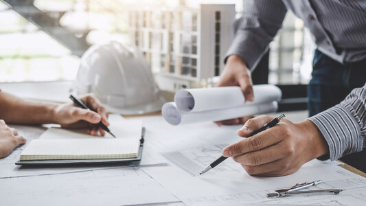 Construction and structure concept of Engineer or architect meeting for project working with partner and engineering tools on model building and blueprint in working site.