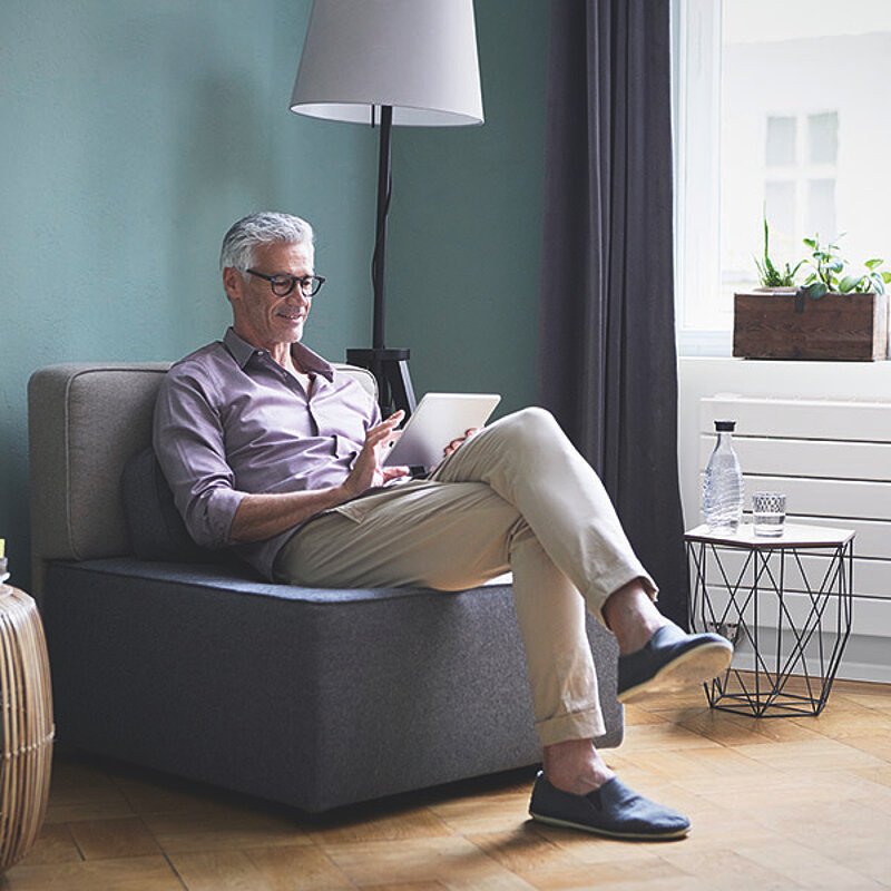 Mature man using tablet at home