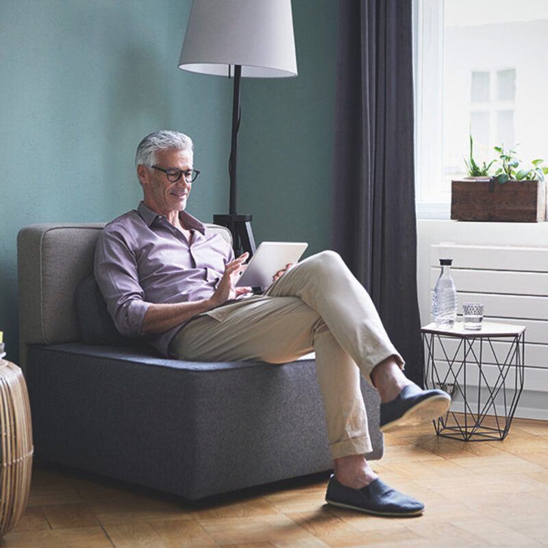 Mature man using tablet at home