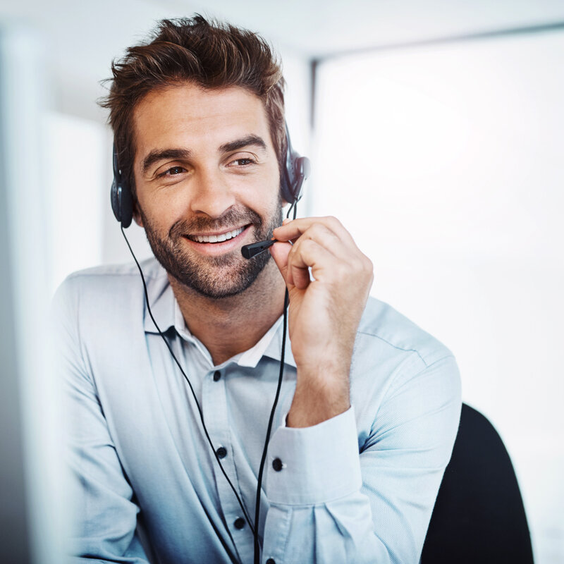 young, call centre agent, working in an office. guy on phone,