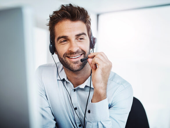 young, call centre agent, working in an office. guy on phone,