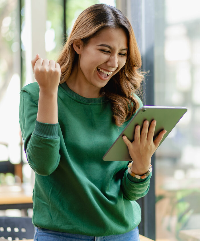 Woman looks at her tablet and smiles